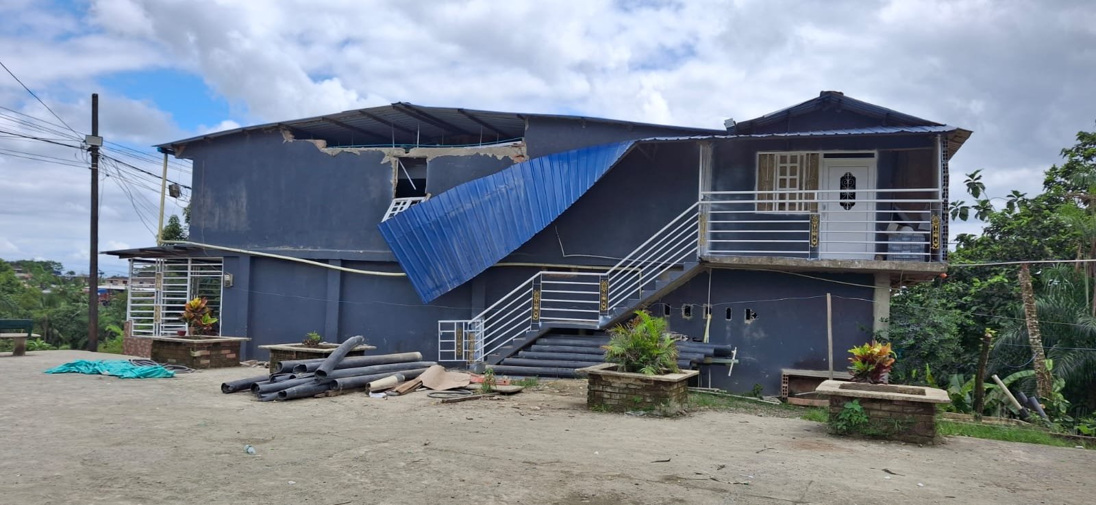 Vivienda de dos plantas con la cubierta metálica desprendida